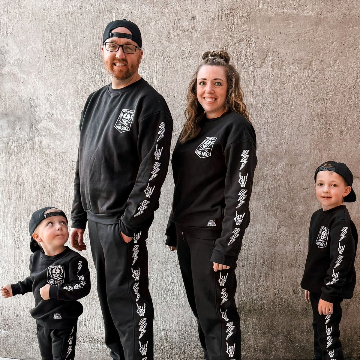 family matching black aftershock crew neck sweatshirts and joggers set lightning bolt and rock hand print little rocker clothing adult and kids outfits