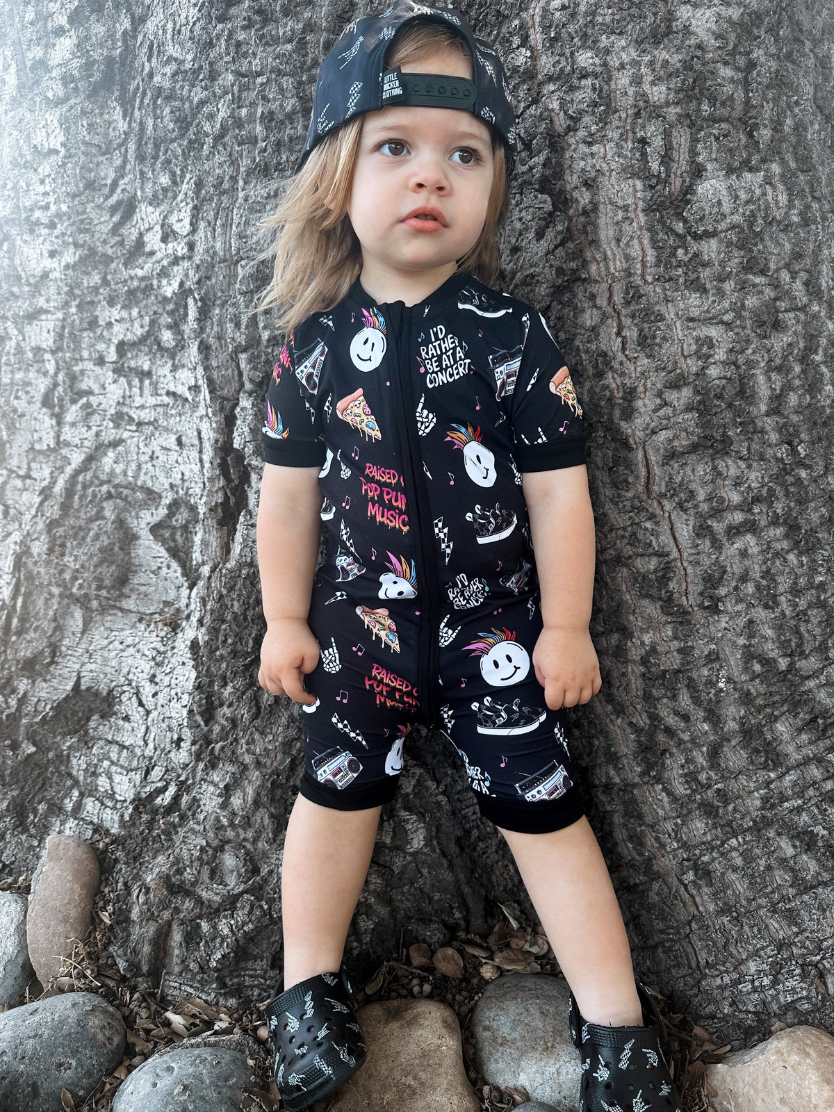 toddler girl wearing pop punk collage pattern short sleeve zip up bamboo pajamas for kids