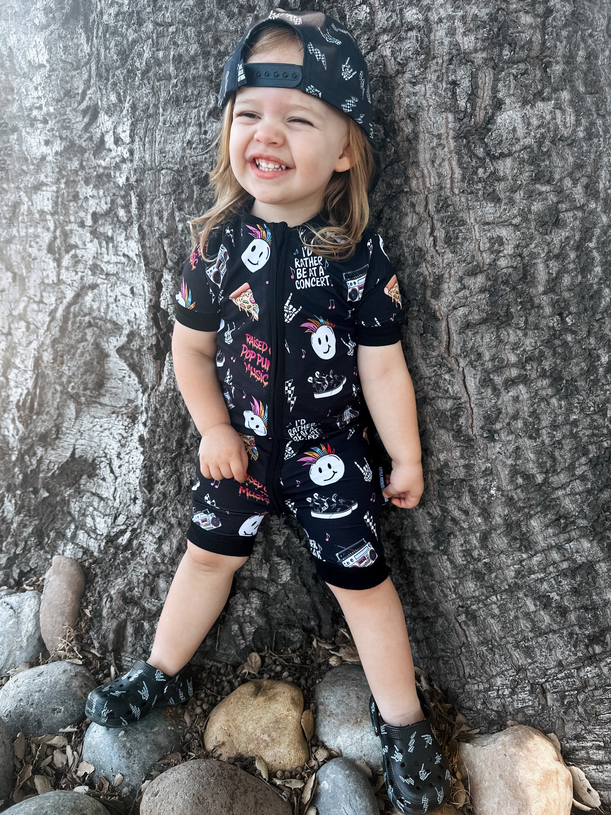 toddler wearing pop punk collage pattern short sleeve zip up bamboo pajamas for kids