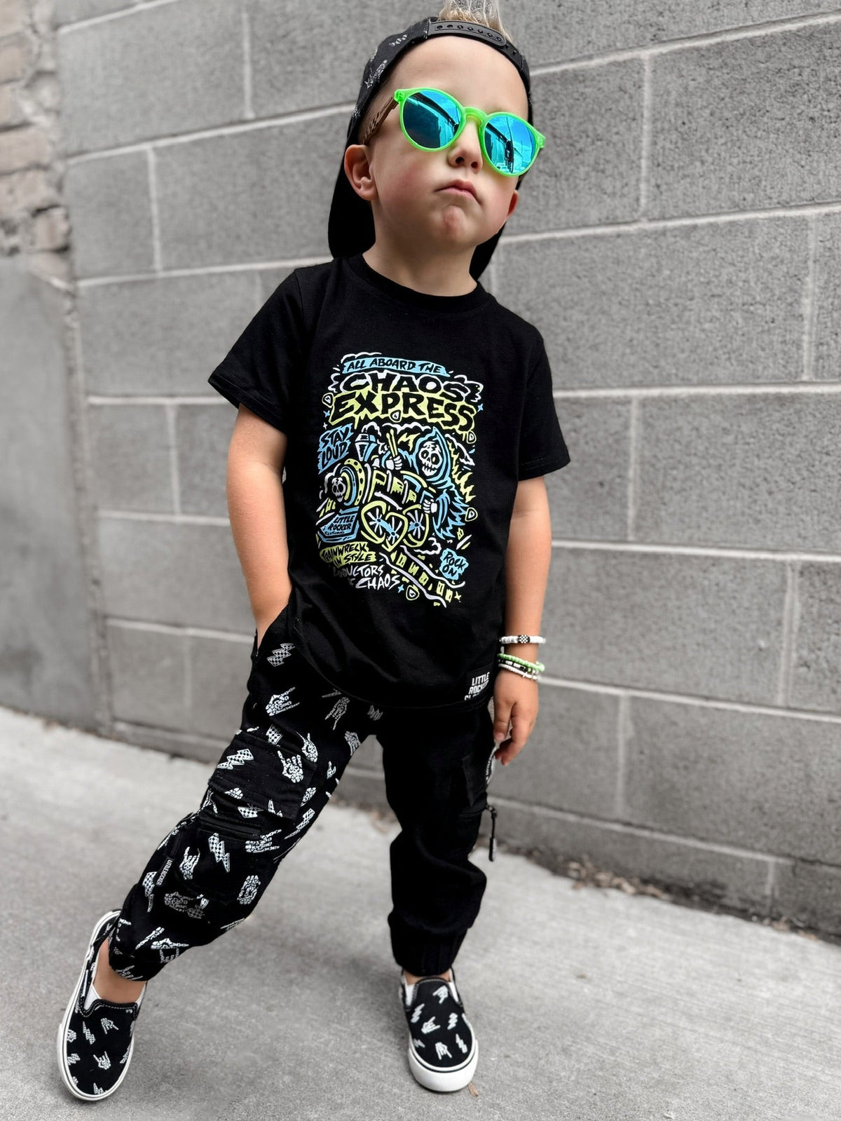 Edgy kid wearing the Kids black chaos express t-shirt featuring rock inspired graphic with train illustration on a graphic tee, rocker style kids apparel