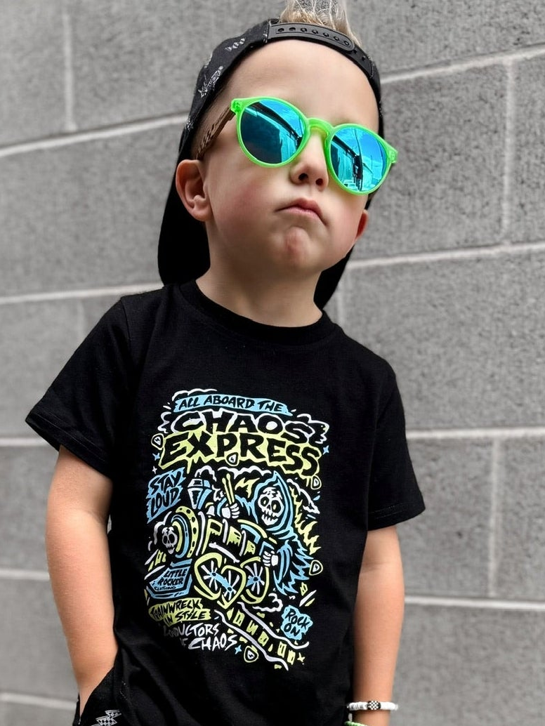 Toddler playing outside in the Kids black chaos express t-shirt featuring rock inspired graphic with train illustration on a graphic tee, rocker style kids apparel
