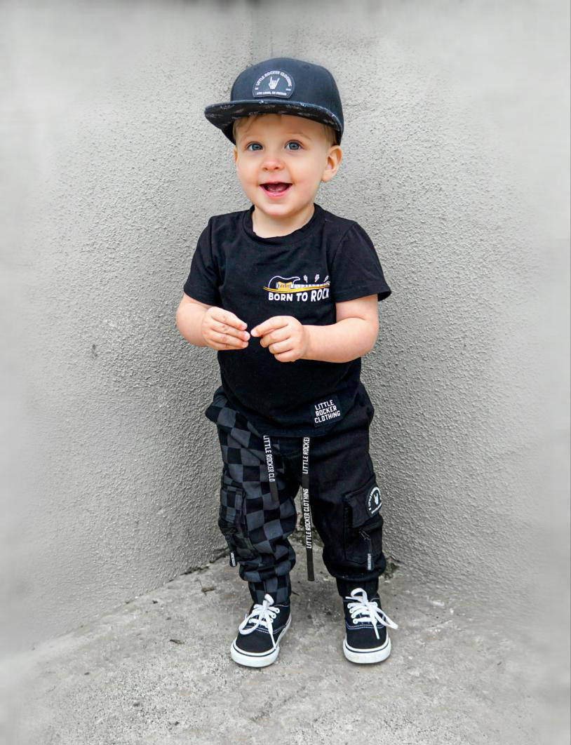 toddler wearing kids half black half checkered cargo joggers black streetwear pants with cargo pockets rocker style toddler to youth sizes little rocker clothing
