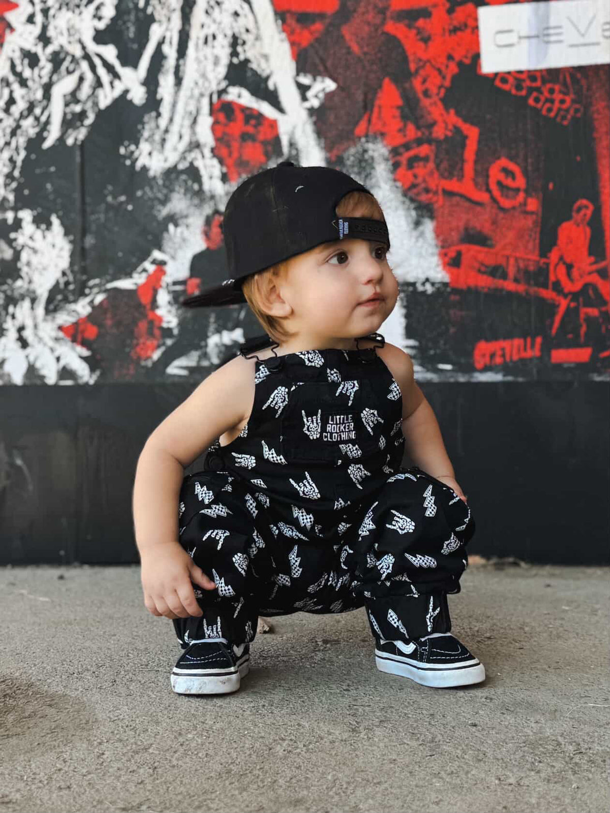 infant wearing kids black bolted bones overalls with lightning bolt and rock hand print matching outfits toddler streetwear little rocker clothing