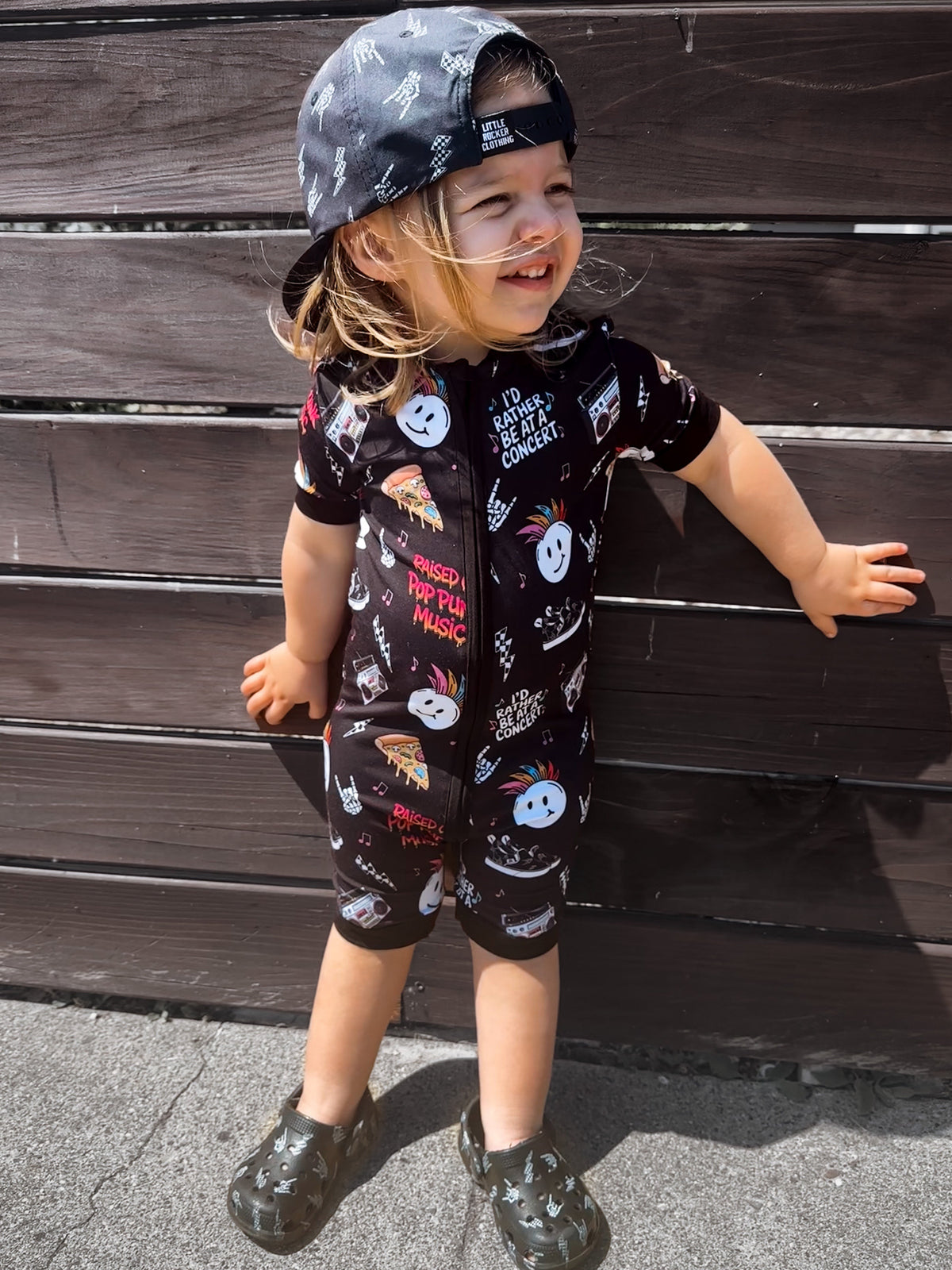 toddler wearing pop punk collage pattern short sleeve zip up bamboo pajamas for kids