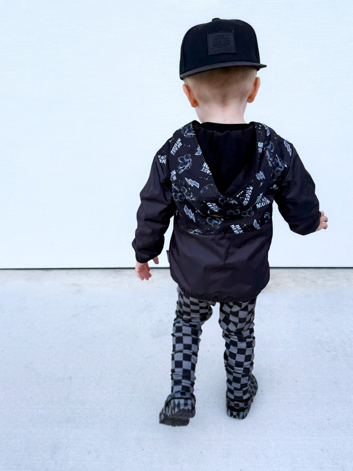 Back side with hood down of Kids Beast Mode black windbreaker jacket with all over graphic print, lightweight rocker style outerwear for kids with zip front and hood