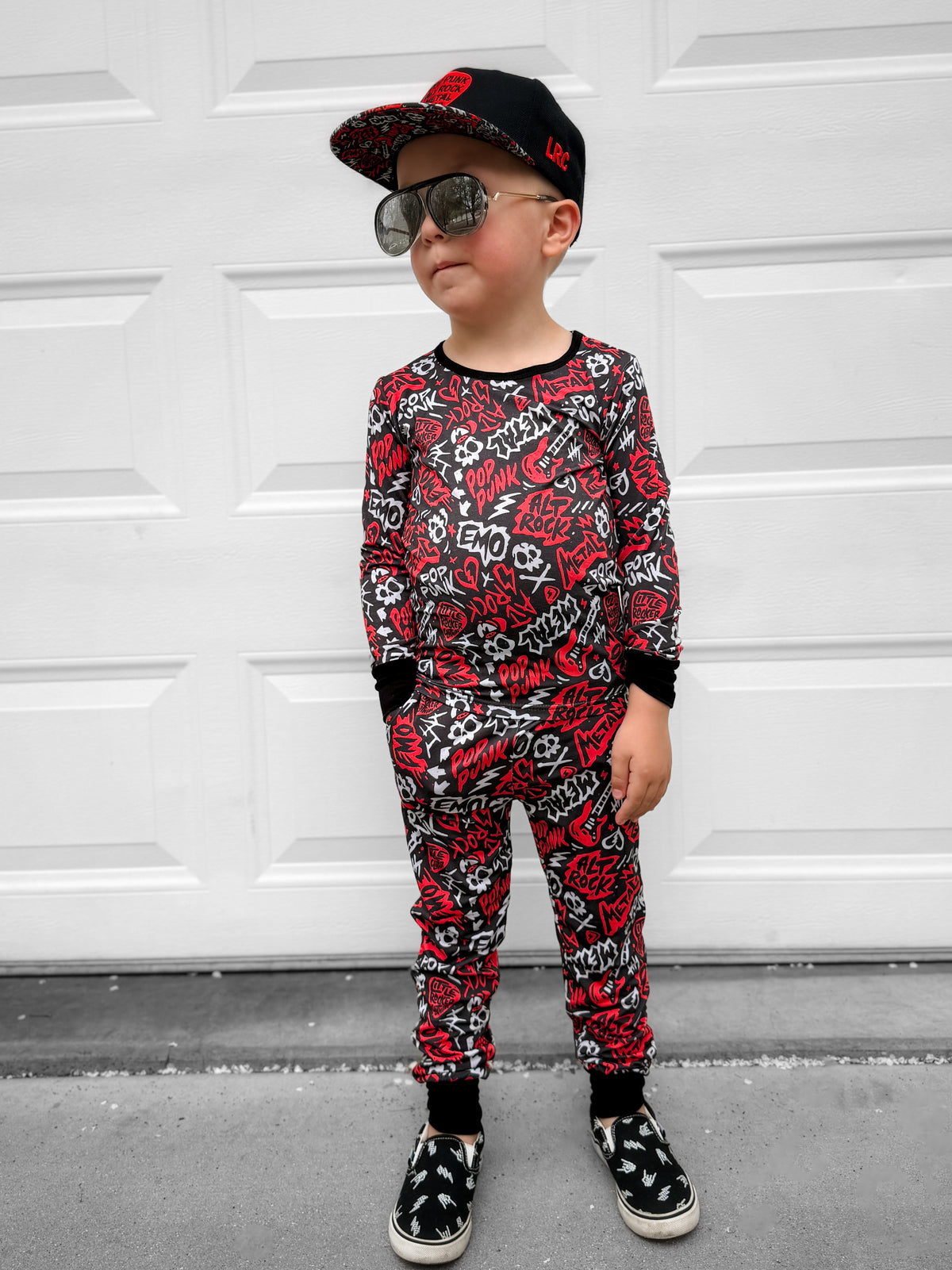 Red and black bamboo two piece pajama set with long sleeves and full length pants, featuring an edgy rock inspired print, made from ultra soft breathable bamboo fabric with a stretchy comfortable fit for toddlers and kids in sizes 2T to 10/12