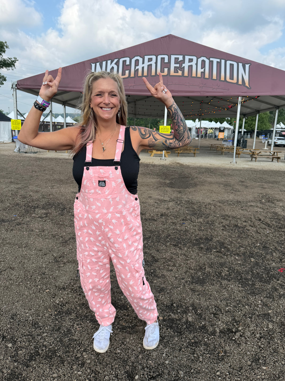 woman at inkcarceration wearing adult bolted bones overalls in pink from little rocker clothing