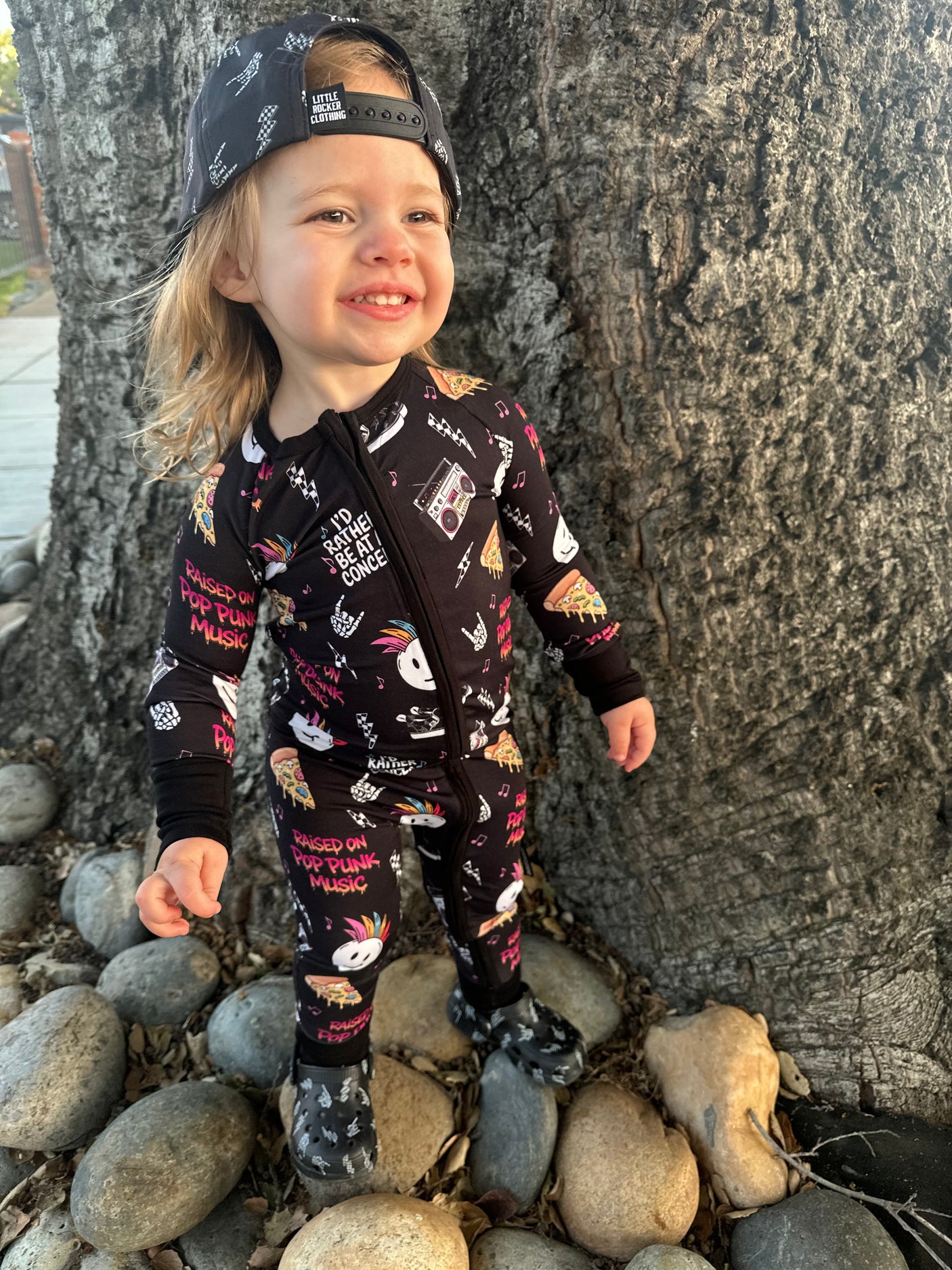 toddler girl wearing pop punk collage pattern long sleeve zip up bamboo pajamas for kids