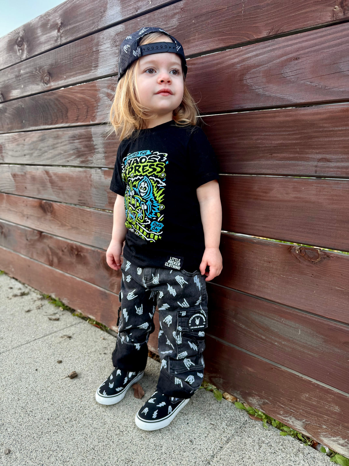 kids wearing black washed baggy jeans with skull pattern styled as edgy kids outfit from Little Rocker Clothing