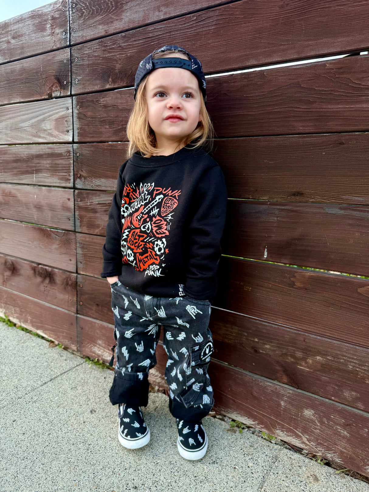 kids outfit featuring black washed baggy jeans with skull pattern edgy kids clothing and rock kids clothing style