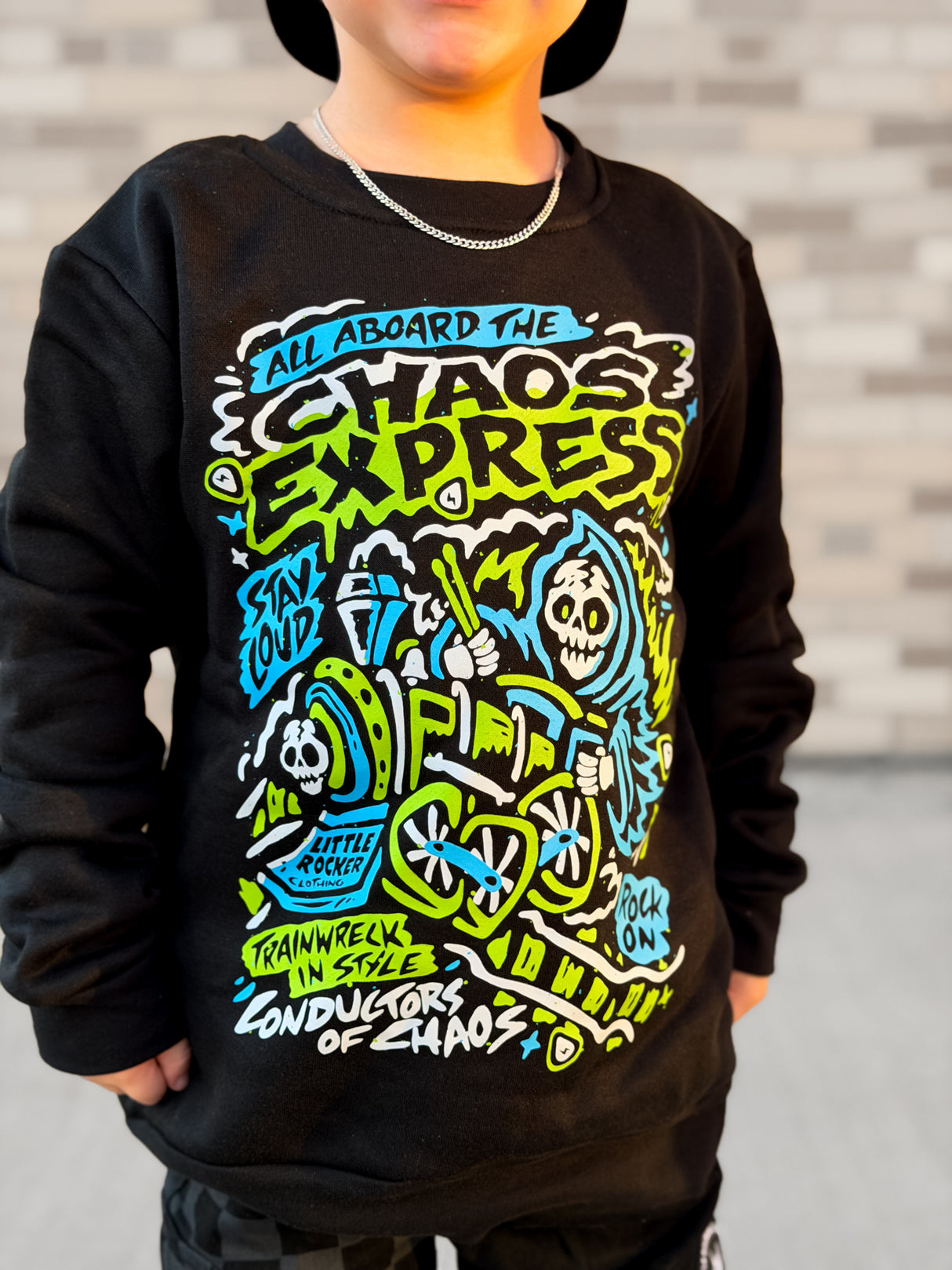 Close up of Kids black Scene Sampler crew neck sweatshirt featuring pop punk, emo, and alt rock graphic with train illustration, rocker style kids apparel