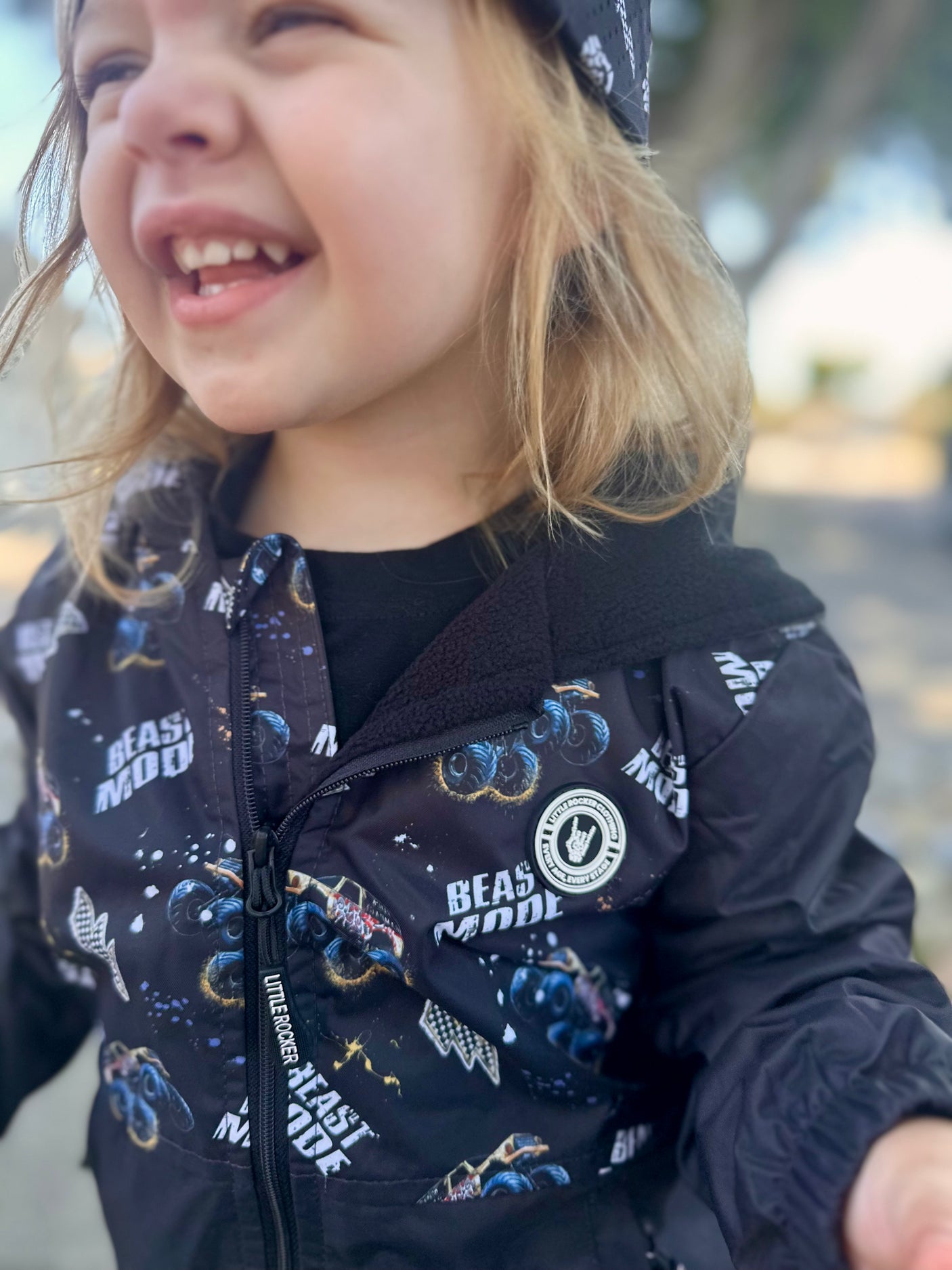 Close up of Kids Beast Mode black windbreaker jacket with all over graphic print, lightweight rocker style outerwear for kids with zip front and hood