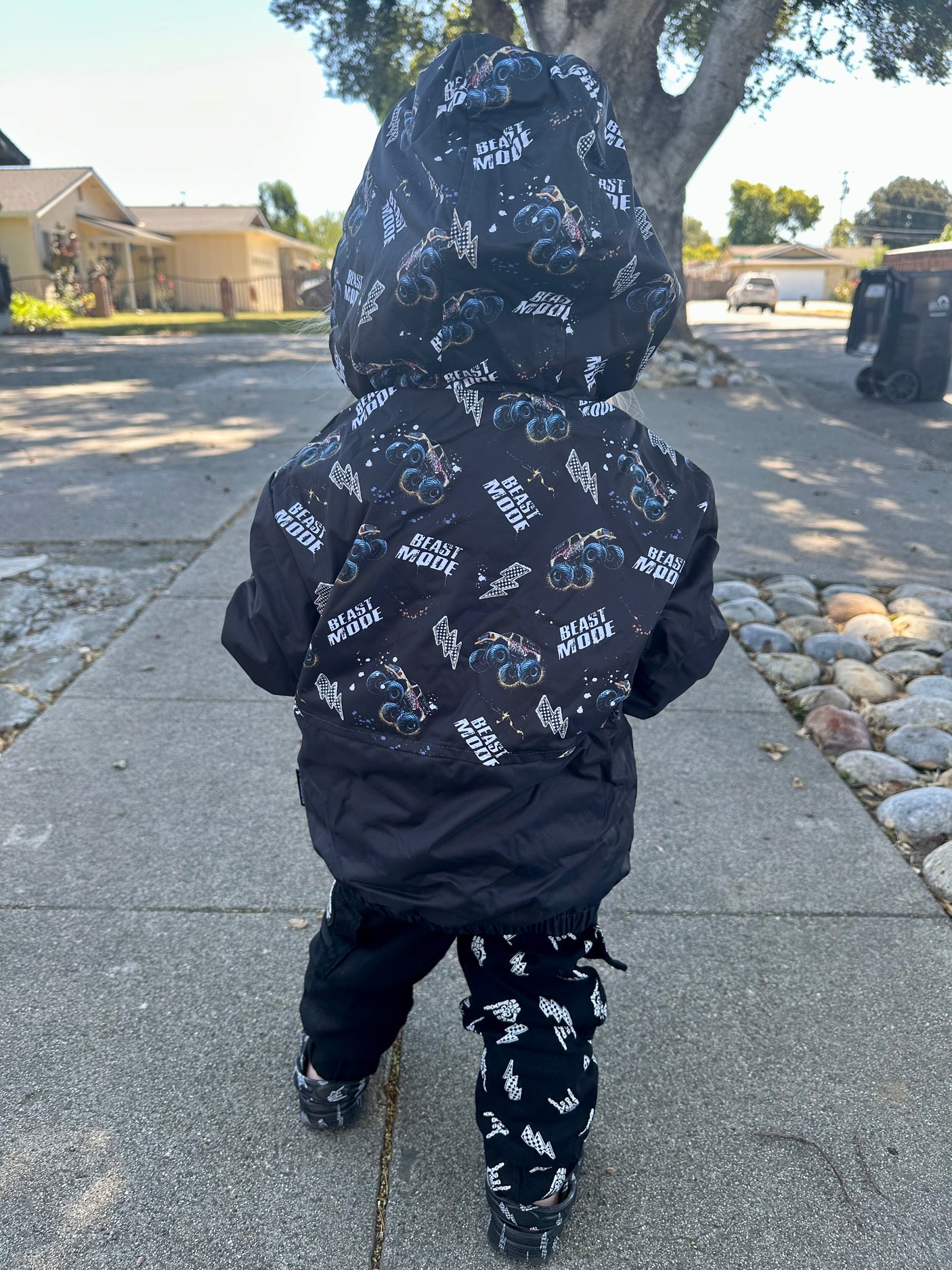 Back side of the Kids Beast Mode black windbreaker jacket with all over graphic print, lightweight rocker style outerwear for kids with zip front and hood