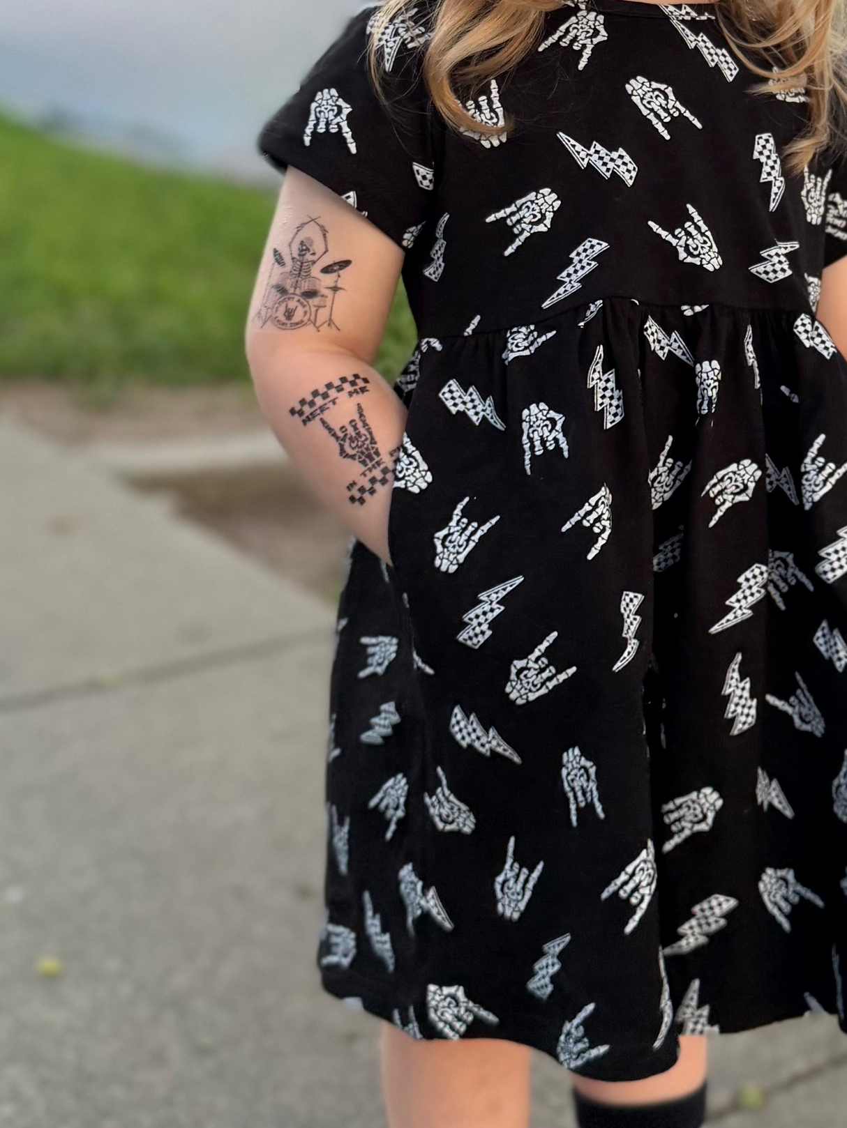 close up of black dress with skeleton hand horns and lightening bolt pattern
