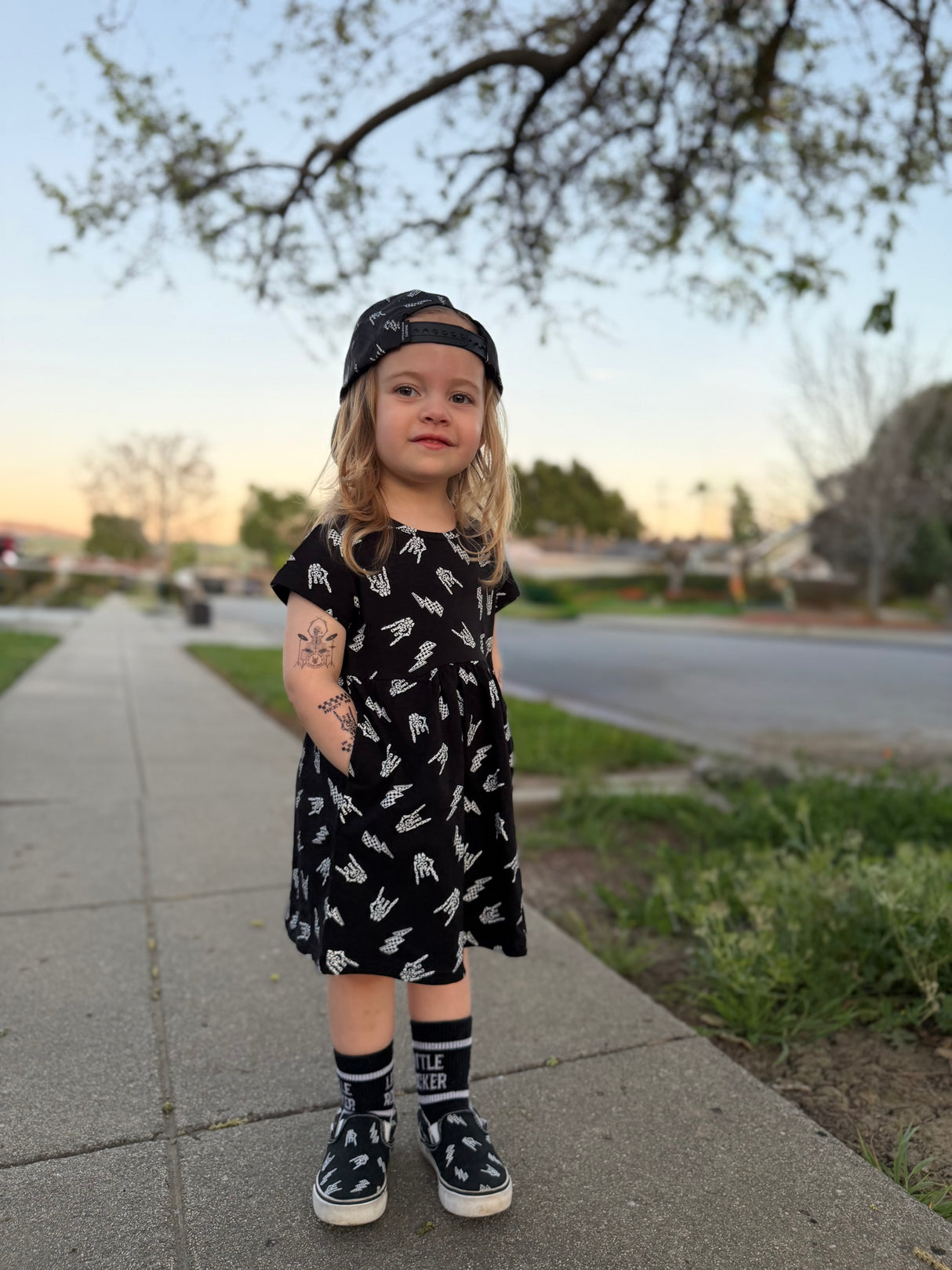 young girl wearing bolted bones pattern black dress