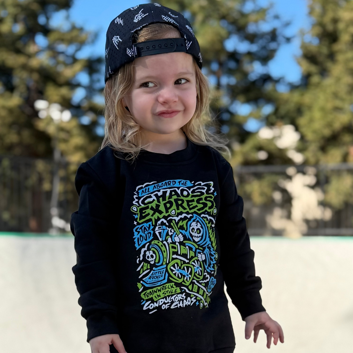 Girl wearing Kids black Scene Sampler crew neck sweatshirt featuring pop punk, emo, and alt rock graphic with train illustration, rocker style kids apparel