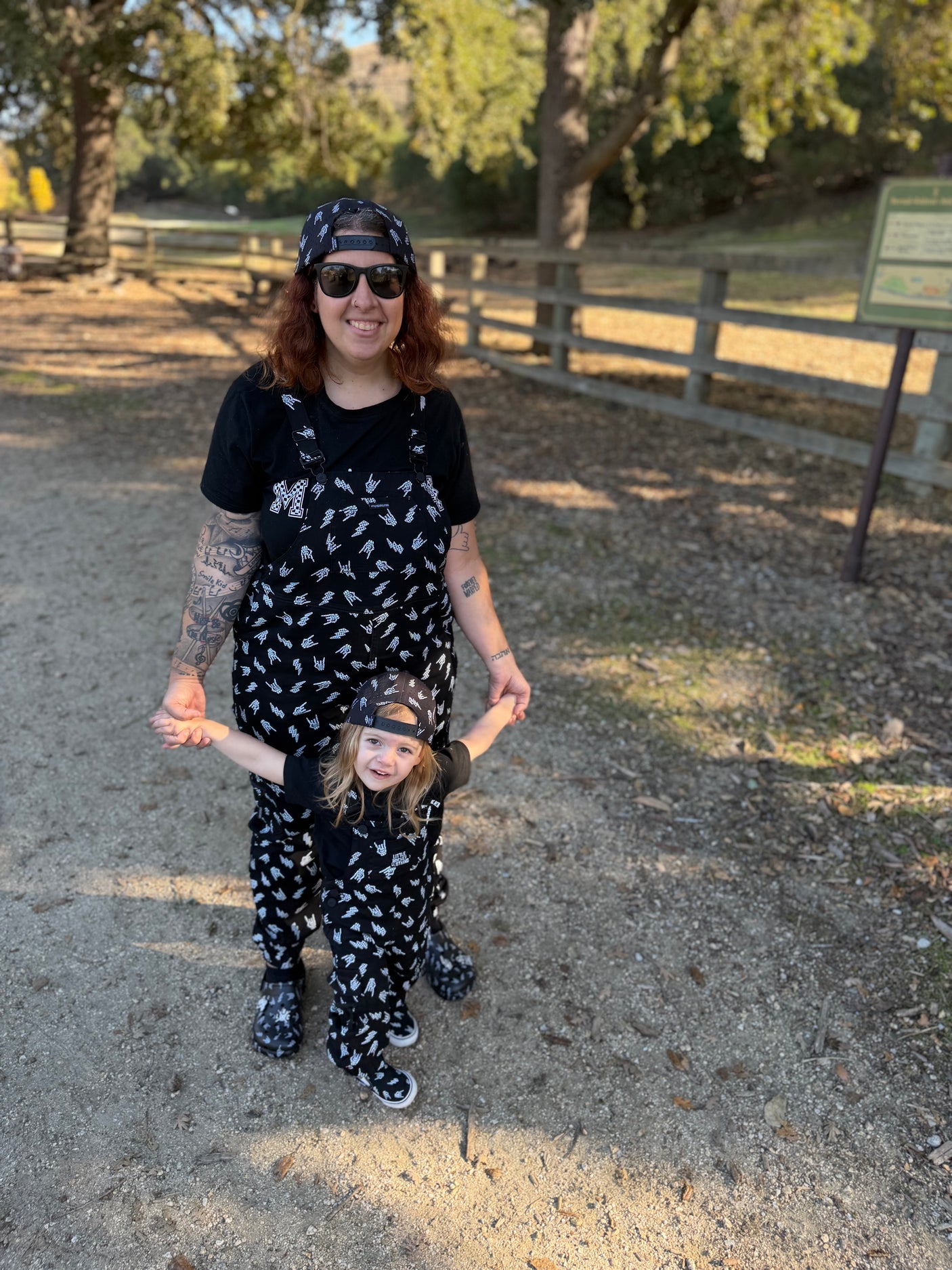 black bolted bones overalls for adults shown with matching kids outfit styled for edgy outfits and everyday wear