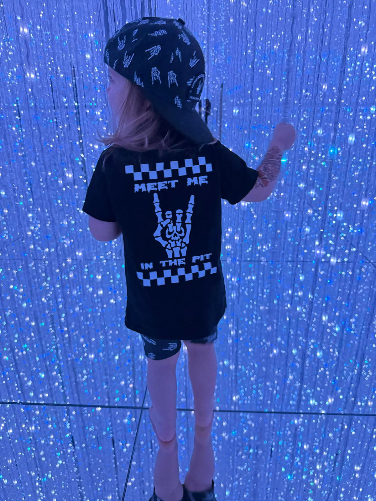 girl wearing meet me in the pit rock inspired outfit in a mirror maze