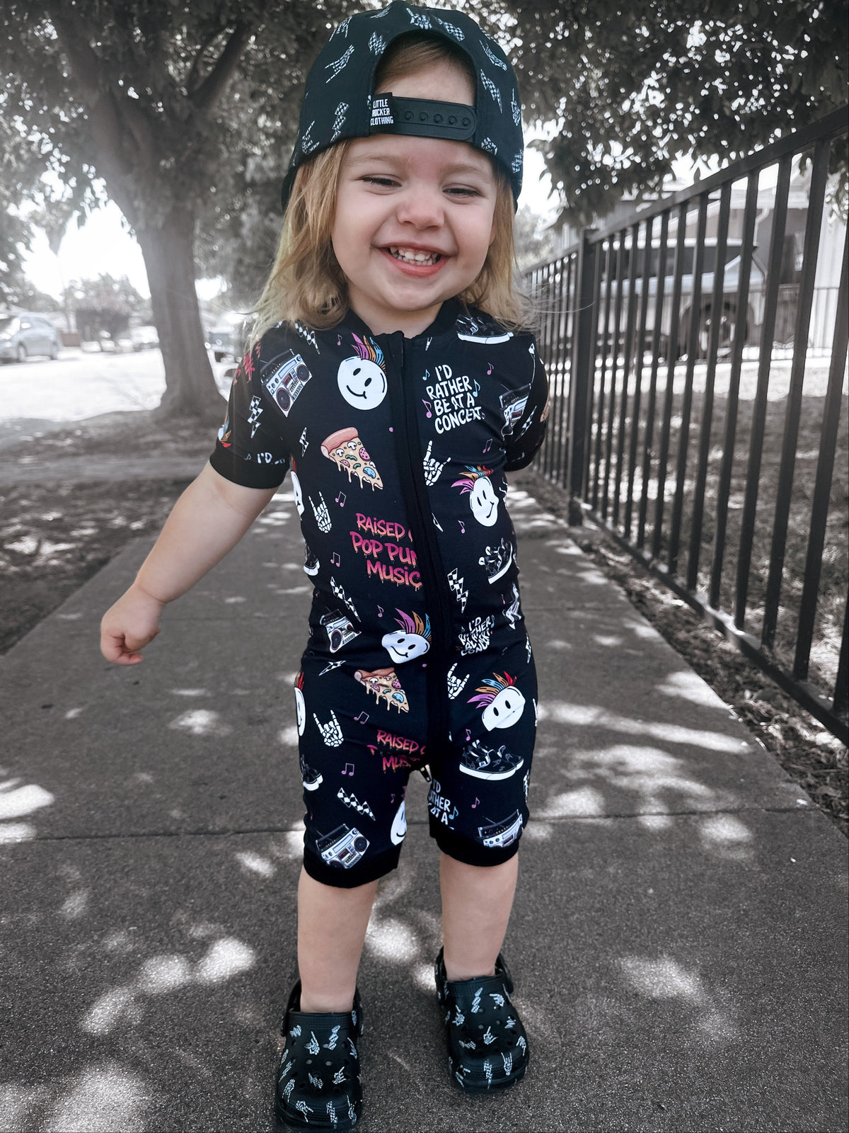 toddler wearing pop punk collage pattern short sleeve zip up bamboo pajamas for kids