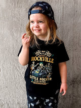 Girl wearing the official welcome to rockville kids graphic tee collaboration, rock festival band style t shirt for kids, black rocker tee with bold music design, little rocker clothing festival apparel