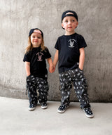 matching kids punk rock outfits featuring black graphic tees meet me in the pit design with alternative kids clothing and streetwear pants