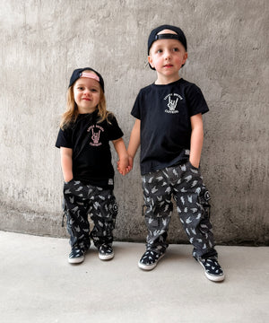 matching kids punk rock outfits featuring black graphic tees meet me in the pit design with alternative kids clothing and streetwear pants