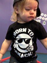 infant girl wearing black kids graphic t-shirt with born to snack text, little rocker clothing rock style outfit 