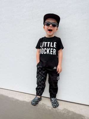 young boy matching his little rocker clothing shirt with kids half black half checkered cargo joggers black streetwear pants with cargo pockets rocker style toddler to youth sizes little rocker clothing
