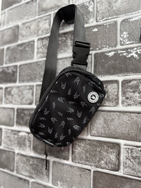 Little Rocker Clothing black Bolted Bones crossbody bag featuring signature skull bolt pattern, adjustable strap crossbody purse with compact functional design, edgy rock style accessory for everyday wear