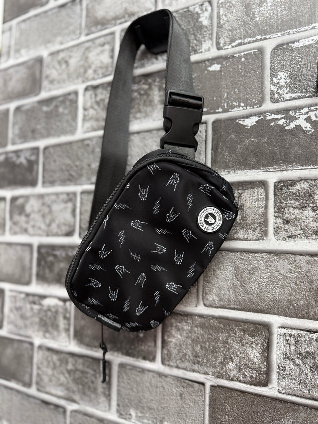 Little Rocker Clothing black Bolted Bones crossbody bag featuring signature skull bolt pattern, adjustable strap crossbody purse with compact functional design, edgy rock style accessory for everyday wear