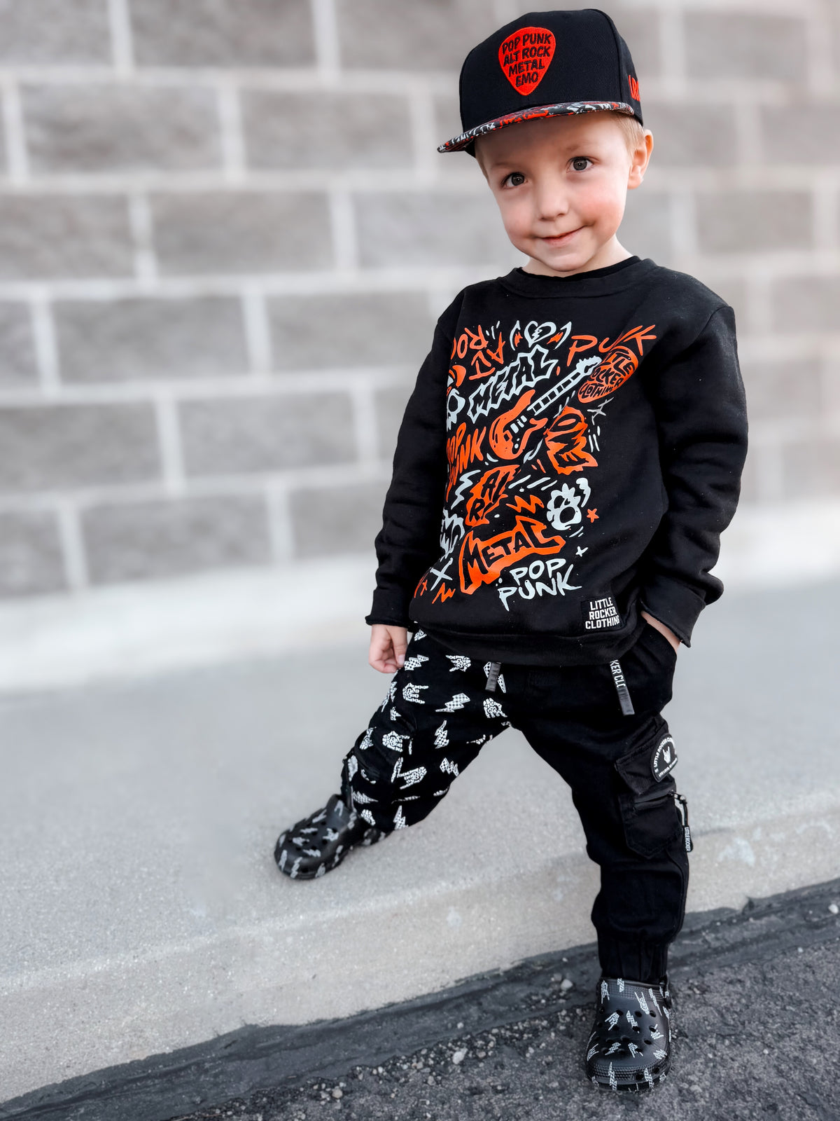 Kid wearing the scene sampler crew neck sweatshirt for kids and adults with pop punk alt rock metal emo graphic design, rocker style apparel, little rocker clothing