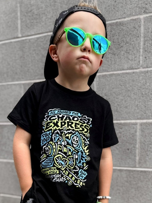 Toddler playing outside in the Kids black chaos express t-shirt featuring rock inspired graphic with train illustration on a graphic tee, rocker style kids apparel