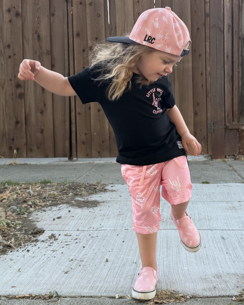 young girl in dancing wearing a mix of pink and black bolted bones clothes from little rocker clothing