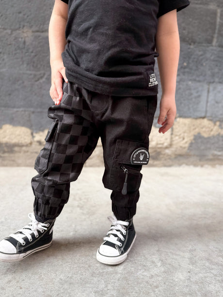 close up of kids half black half checkered cargo joggers black streetwear pants with cargo pockets rocker style toddler to youth sizes little rocker clothing