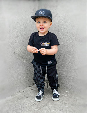 toddler wearing kids half black half checkered cargo joggers black streetwear pants with cargo pockets rocker style toddler to youth sizes little rocker clothing