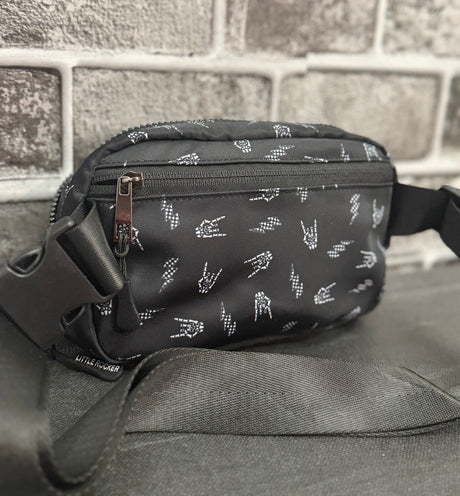 Little Rocker Clothing black Bolted Bones crossbody bag featuring signature skull bolt pattern, adjustable strap crossbody purse with compact functional design, edgy rock style accessory for concert festivals