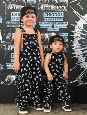 boys at aftershock music festival wearing kids black bolted bones overalls with lightning bolt and rock hand print matching outfits toddler streetwear little rocker clothing