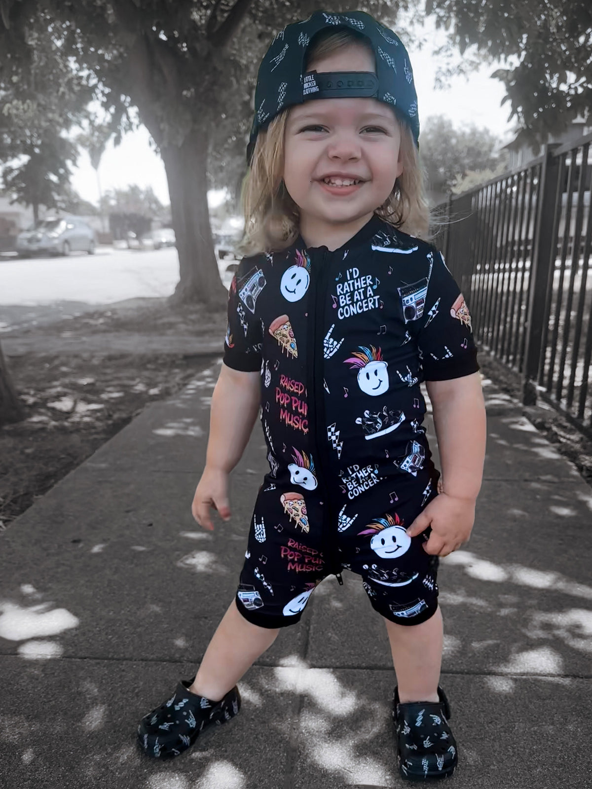 toddler wearing pop punk collage pattern short sleeve zip up bamboo pajamas for kids