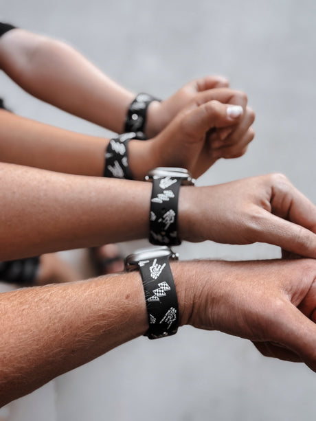 adults and kids wearing bolted bones rock on and lightening bolts black apple watch bands