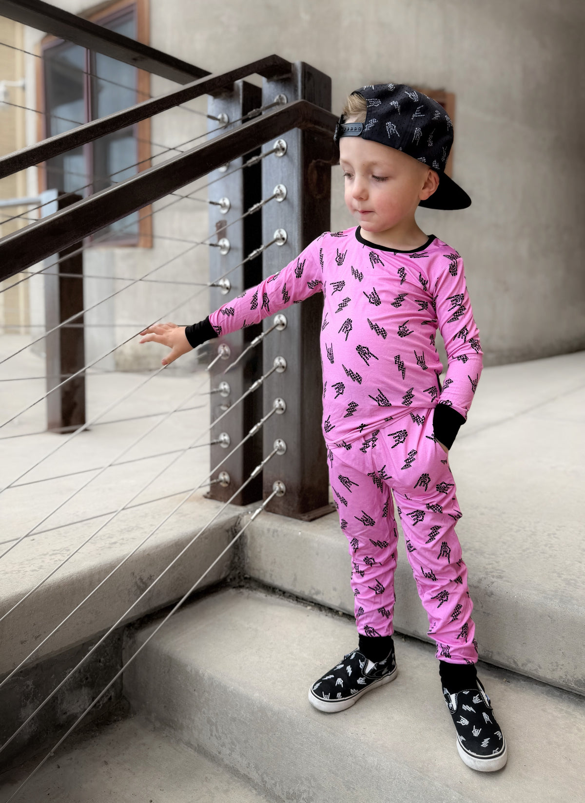 Pink bamboo two piece pajama set with long sleeves and full length pants, featuring an edgy rock inspired print, made from ultra soft breathable bamboo fabric with a stretchy comfortable fit for toddlers and kids in sizes 2T to 10/12