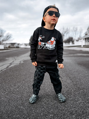 boy in the little rocker clothing christmas crew neck and kids half black half checkered cargo joggers black streetwear pants with cargo pockets rocker style toddler to youth sizes little rocker clothing