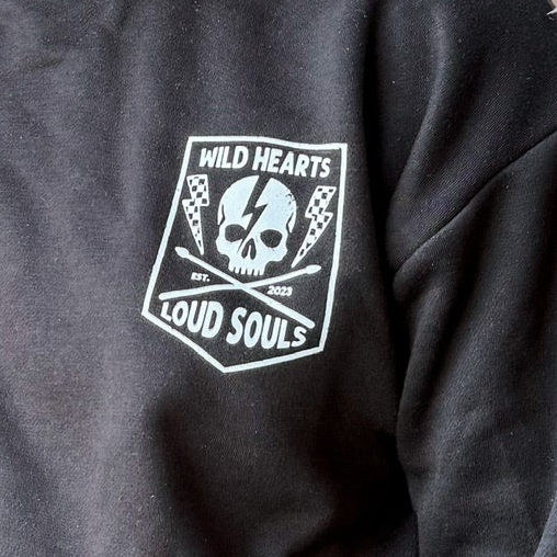 close up of front crew neck sweatshirts and joggers set lightning bolt and rock hand print little rocker clothing adult and kids outfits