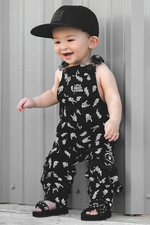 infant wearing kids black bolted bones overalls with lightning bolt and rock hand print matching outfits toddler streetwear little rocker clothing