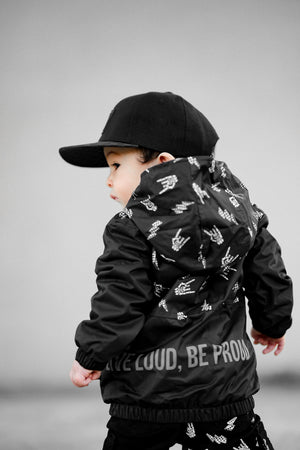 Back side of Kids bolted bones black windbreaker jacket with all over graphic print, lightweight rocker style outerwear for kids with zip front and hood