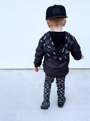 Back side with hood down of Kids Beast Mode black windbreaker jacket with all over graphic print, lightweight rocker style outerwear for kids with zip front and hood