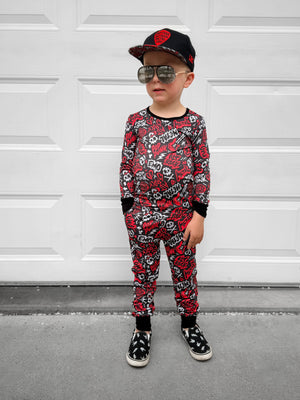 Red and black bamboo two piece pajama set with long sleeves and full length pants, featuring an edgy rock inspired print, made from ultra soft breathable bamboo fabric with a stretchy comfortable fit for toddlers and kids in sizes 2T to 10/12
