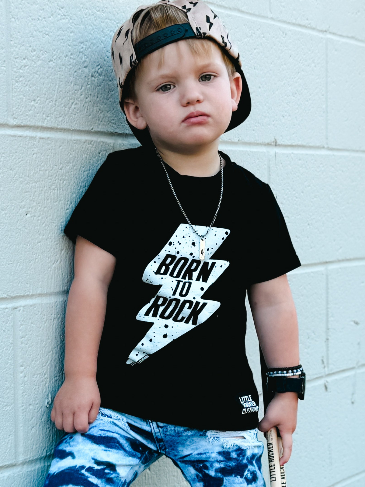 black kids graphic t-shirt with lightening bolt and born to rock text, little rocker clothing rock style outfit for toddlers and kids 
