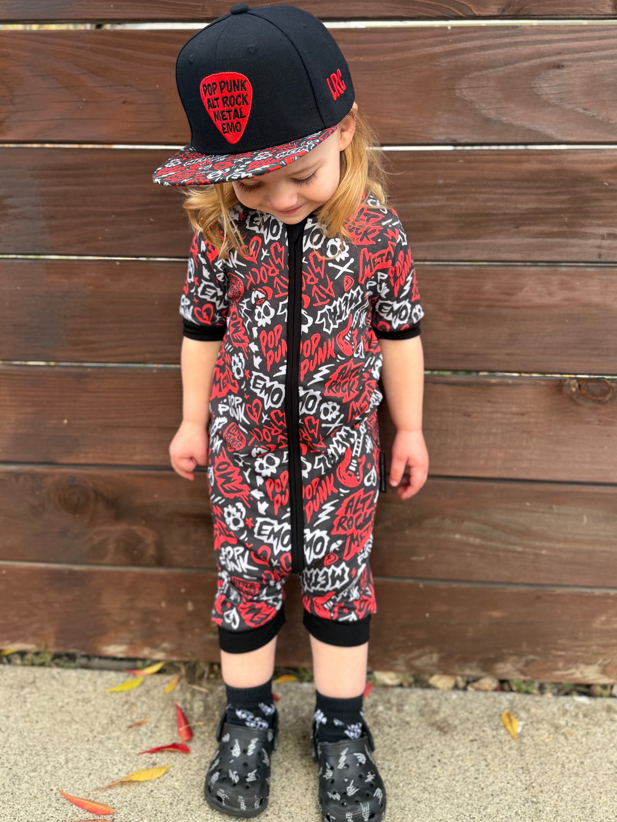 Black and Red baby shortie pajamas featuring an edgy rock-inspired print, made from ultra-soft breathable fabric, designed for babies and toddlers up to size 5T with a comfy stretchy fit and short sleeves for warmer nights