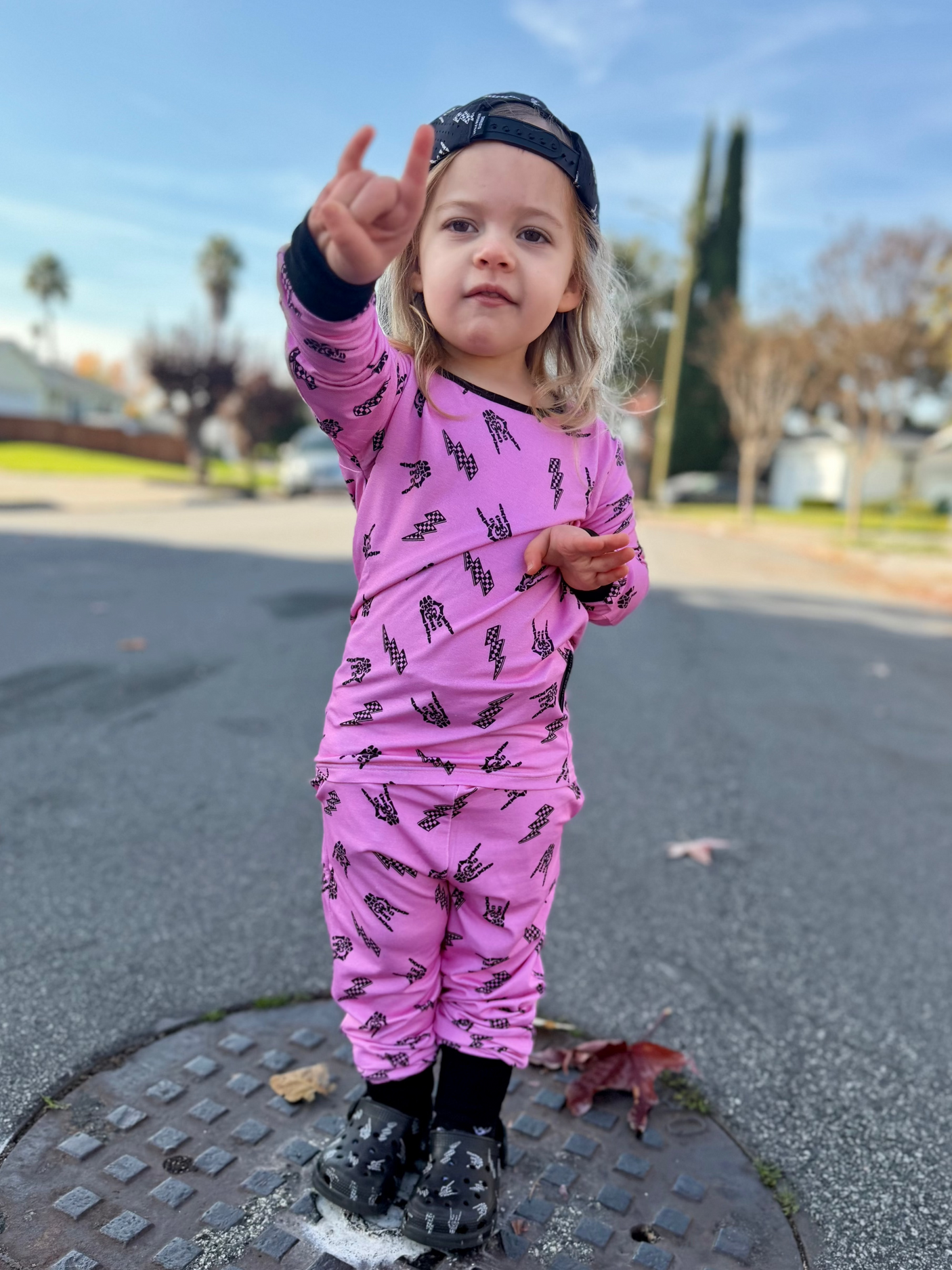 Pink bamboo two piece pajama set with long sleeves and full length pants, featuring an edgy rock inspired print, made from ultra soft breathable bamboo fabric with a stretchy comfortable fit for toddlers and kids in sizes 2T to 10/12