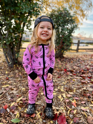 Pink bamboo pajama set with long sleeves and full length pants, featuring an edgy rock inspired print, made from ultra soft breathable bamboo fabric with a stretchy comfortable fit for babies and kids up to 3T